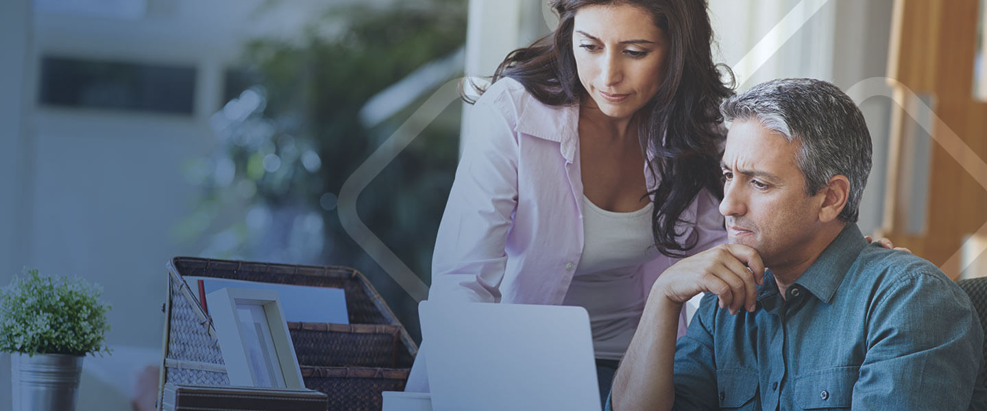 man and woman looking at laptop