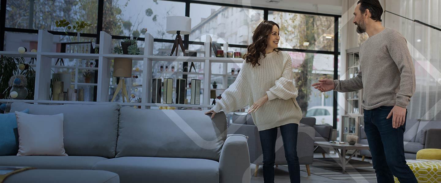 man and woman shopping for couch