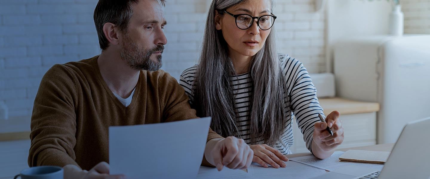 Man and woman reviewing bills