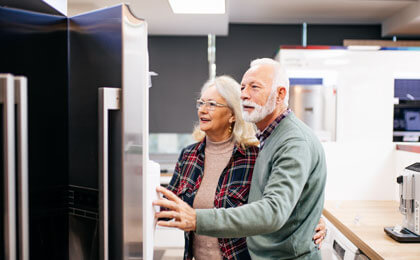 couple shopping for new refrigerator