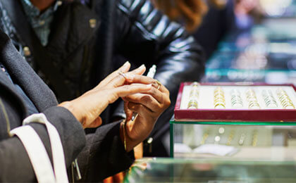 woman trying on ring in store