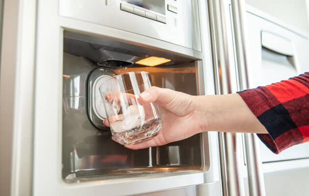 close up of fridge water and ice dispenser