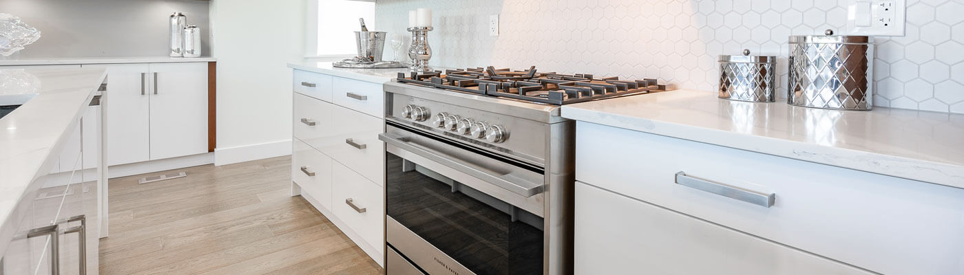 white kitchen with large oven and stove range