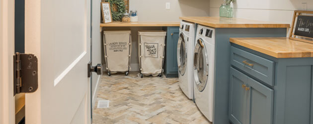 washer and dryer in laundry room with clothes hampers