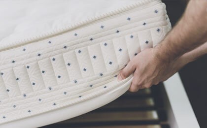 mattress corner being lifted to show squish