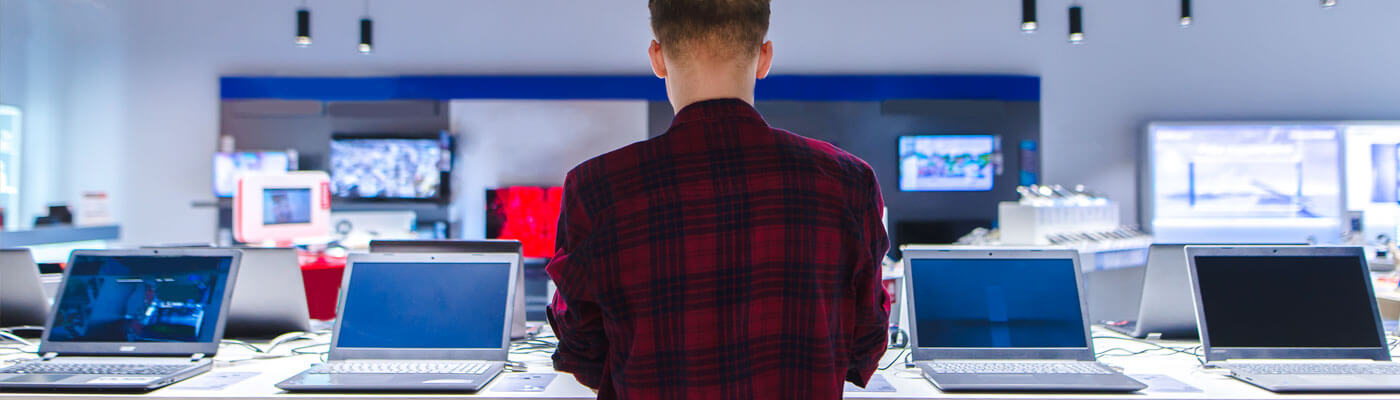 man shopping for laptops in store