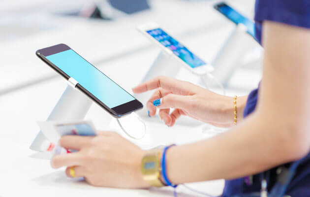 woman using cell phone in store display