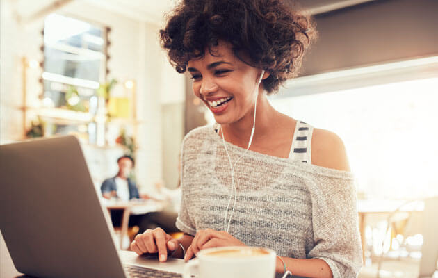 woman on video call on laptop in coffee shop