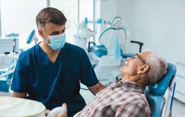 elderly man consulting with dental hygienist