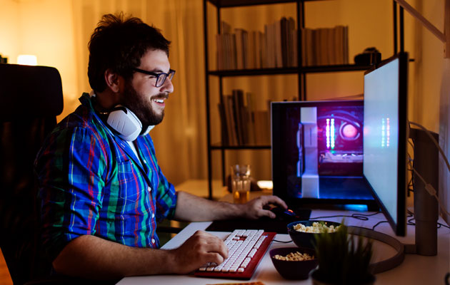 man using his desktop computer in his office