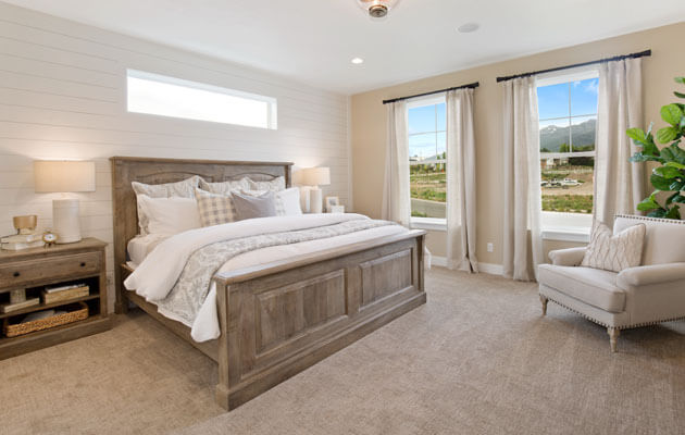 cream colored master bedroom with matching furniture