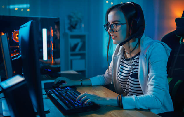 woman playing on gaming desktop computer