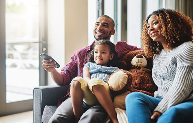 Family is watching tv at home