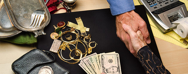 handshaking and trading collectibles and jewelry with money