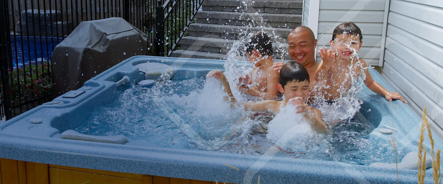 dad sons splashing hot tub