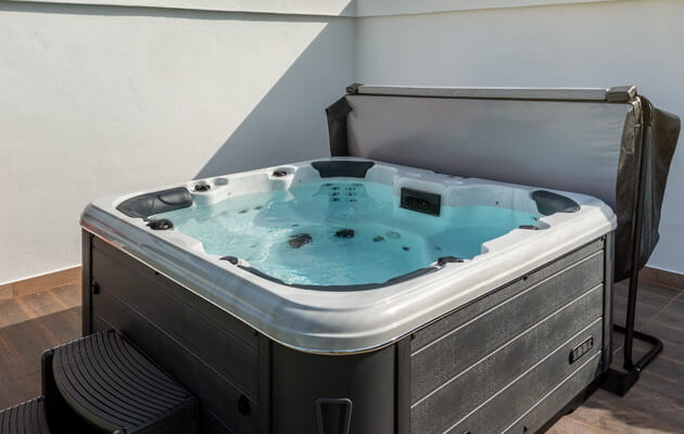 hot tub with cover on deck