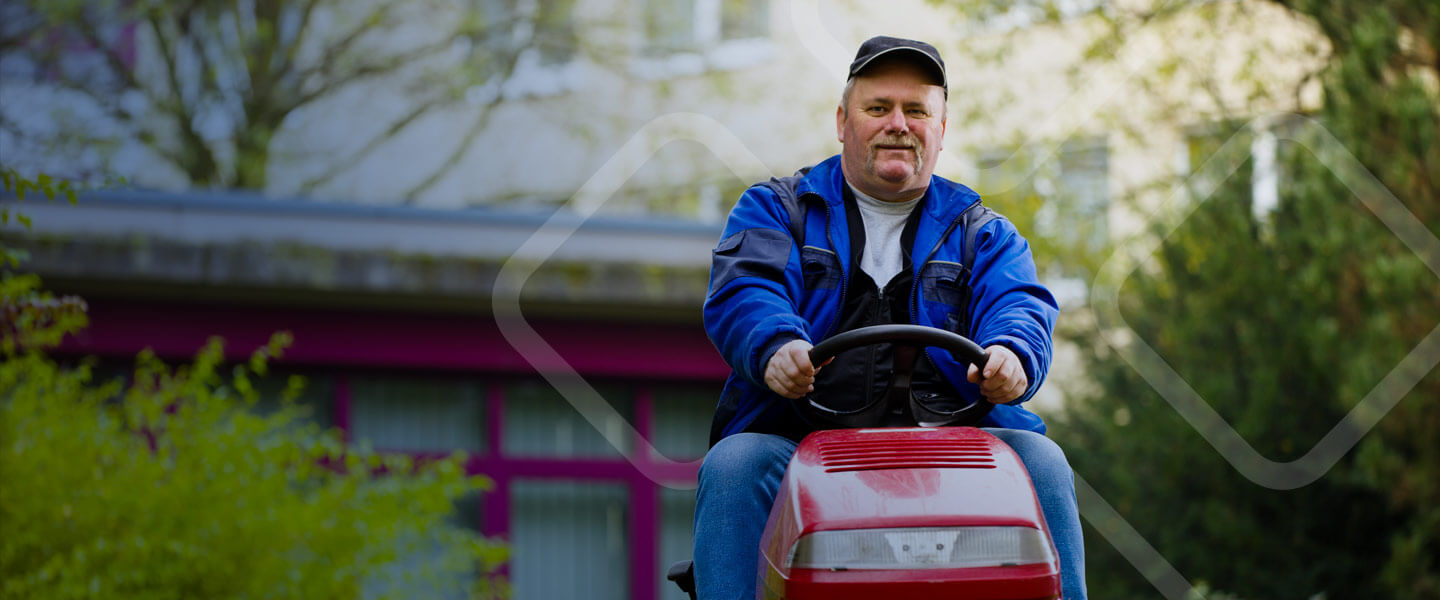 man riding zero turn lawn mower