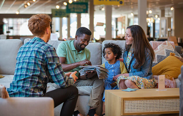 Family choosing the new sofa in a furniture store