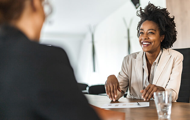 Smiling businesswoman talking during a meeting.