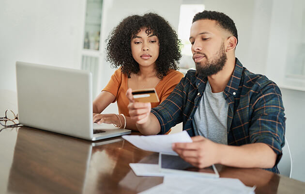 Couple using credit card to pay online.