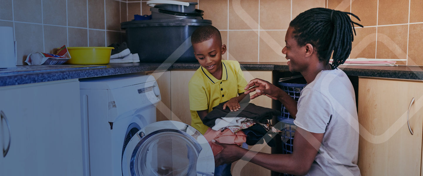 father and son folding laundry