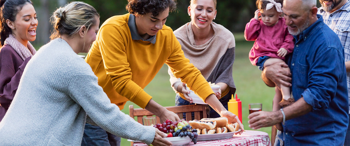 Multi-generation family enjoying backyard cookout