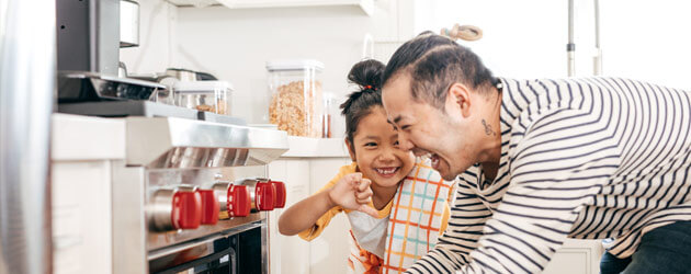 father and daughter baking cookies