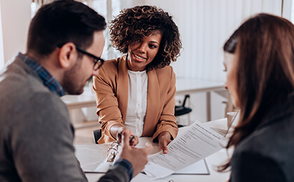 Couple consulting with a female financial manager