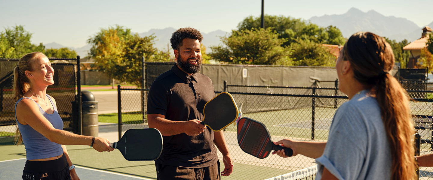 Young adults playing Pickleball at a public court.