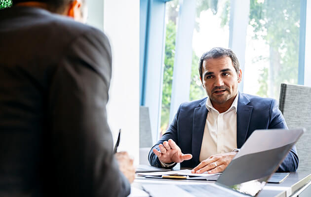 Hispanic businessman meeting with client.