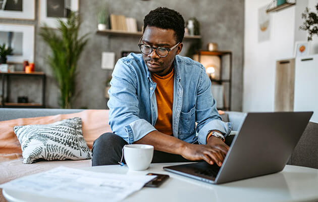 Man at home managing household finances.