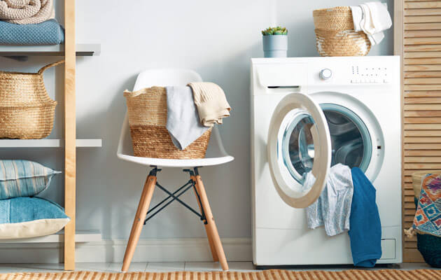 washing machine in washroom with laundry