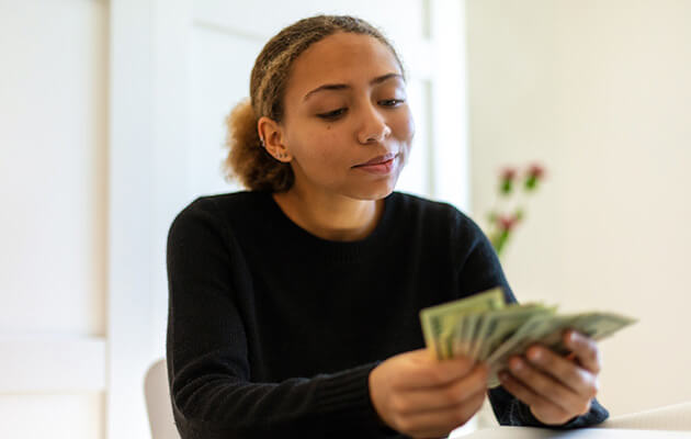 Happy woman counting money.