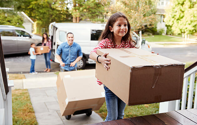 Family unloads van on moving day.