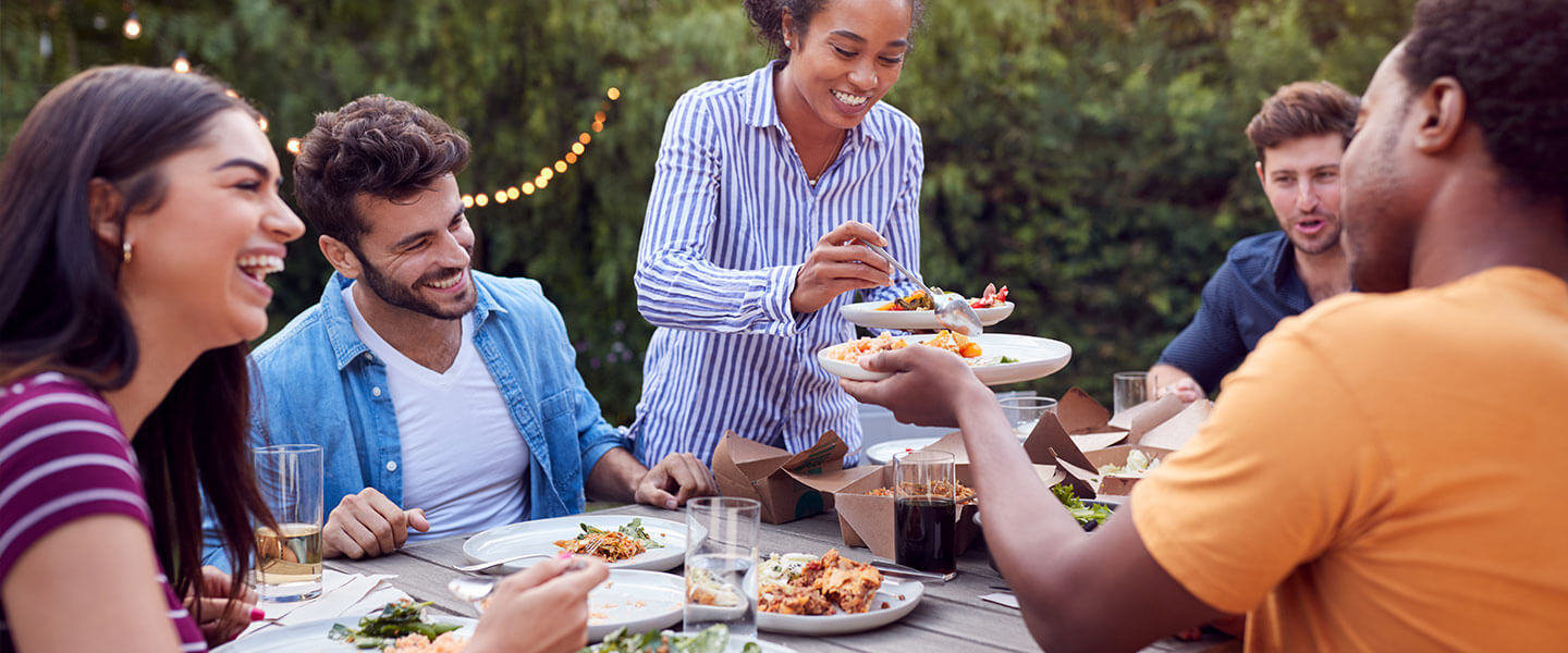 Friends enjoying food outside.