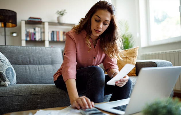 young woman calculating bills