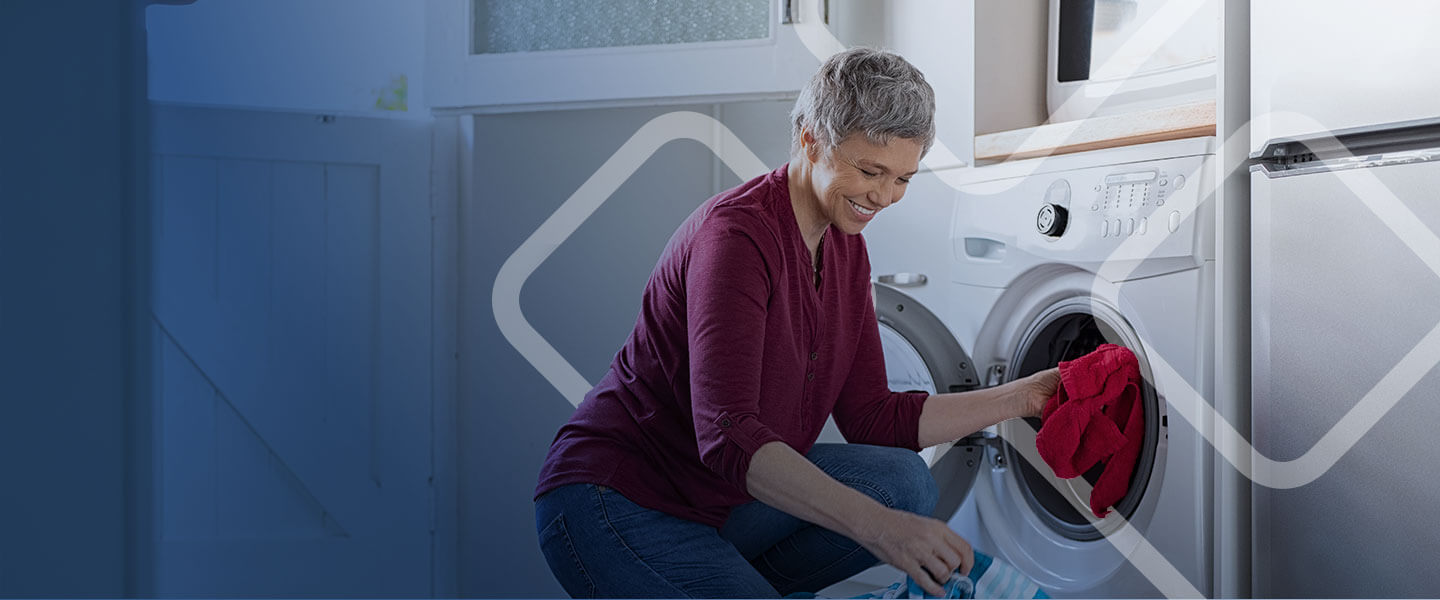 old women doing laundry with washer.