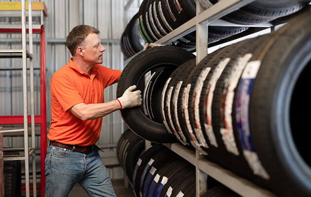 men picking up tires in store