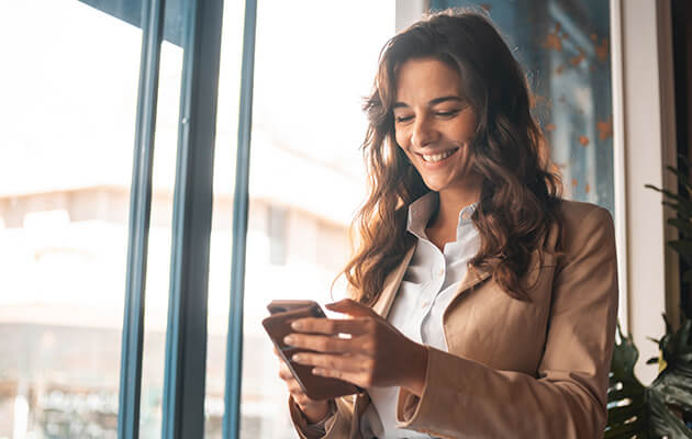 professional women looking at her phone and smile