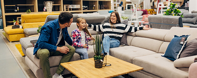 family with kid shopping for furniture in store