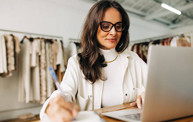 women working on laptop in a store